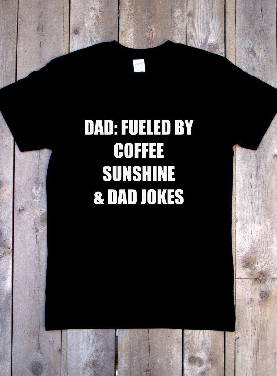 Dad Fueled by Coffee Sunshine and Dad Jokes Shirt — flat lay photo